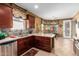 Modern kitchen with stainless steel appliances, breakfast nook, and ample counter space at 1422 S Colt Dr, Gilbert, AZ 85296