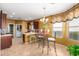 Eat-in kitchen featuring a chandelier, dark wood cabinets, and tile floors at 1422 S Colt Dr, Gilbert, AZ 85296