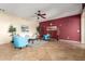 Bright living room featuring a ceiling fan, tile flooring, and an accent wall at 1422 S Colt Dr, Gilbert, AZ 85296