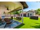 Inviting covered patio with ceiling fans, swing, seating, and backyard with hot tub and detached garage at 1431 E Mclellan Blvd, Phoenix, AZ 85014