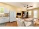 Open living area featuring a Murphy bed, adjacent kitchen, and comfortable seating with wood flooring at 1431 E Mclellan Blvd, Phoenix, AZ 85014