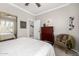 Inviting bedroom with bright window view, ceiling fan, dresser, and welcoming decor at 1431 E Winged Foot Dr, Chandler, AZ 85249