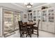 Cozy dining area with a table set for four, built-in cabinets, and sliding glass doors to the patio at 1431 E Winged Foot Dr, Chandler, AZ 85249