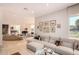 Open-concept living room with travertine floors, a large sofa, and a piano in the background at 1502 E Treasure Cove Dr, Gilbert, AZ 85234