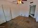 This bedroom features hardwood floors and a ceiling fan, offering potential for a comfortable living space at 1637 E Brill St, Phoenix, AZ 85006
