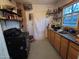 Functional kitchen with wood cabinets and a large window for natural light at 1637 E Brill St, Phoenix, AZ 85006