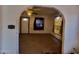 View of the living room highlighting the arched entrance, natural light, and potential for a cozy atmosphere at 1637 E Brill St, Phoenix, AZ 85006