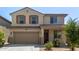 Charming two-story home with neutral stucco, a tile roof, an attached garage and low maintenance landscaping at 16959 W Diana Ave, Waddell, AZ 85355