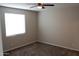 Cozy bedroom featuring neutral carpet and a well-lit window creating a comfortable space at 17353 W Via De Luna Dr, Surprise, AZ 85387