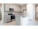 Modern kitchen featuring gray cabinets, stainless steel appliances, and a kitchen island with a sink at 17353 W Via De Luna Dr, Surprise, AZ 85387
