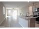 Open floor plan featuring bright living area, neutral colors, and an island with a granite countertop at 17353 W Via De Luna Dr, Surprise, AZ 85387