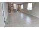 Inviting living room with neutral tones, tile floors, and a glimpse of the open kitchen area at 17353 W Via De Luna Dr, Surprise, AZ 85387