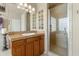 Well-lit bathroom with a vanity with decorative lights, stone countertops, and glass-enclosed shower at 17629 N 24Th Way, Phoenix, AZ 85032