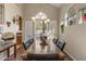 Elegant dining room featuring a stylish chandelier, hardwood floors, and large windows with backyard views at 17629 N 24Th Way, Phoenix, AZ 85032