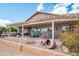 Beautiful backyard with covered patio, desert landscaping, and decorative pottery at 17637 N Goldwater Dr, Surprise, AZ 85374