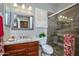 Bathroom features a decorative mirror and a glass-enclosed shower with stylish tile at 17637 N Goldwater Dr, Surprise, AZ 85374