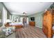 Spacious primary bedroom with a ceiling fan, shutters and wood-look flooring at 17637 N Goldwater Dr, Surprise, AZ 85374