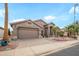 Charming single-story home featuring a three car garage and desert landscaping at 17637 N Goldwater Dr, Surprise, AZ 85374