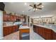 Well-lit kitchen with cherry cabinets, updated appliances and an island with a sink at 17637 N Goldwater Dr, Surprise, AZ 85374