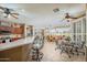 Bright, open living space with breakfast bar, ceiling fans, and tile flooring at 17637 N Goldwater Dr, Surprise, AZ 85374