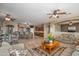 Bright, open living space with breakfast bar, ceiling fans, and tile flooring at 17637 N Goldwater Dr, Surprise, AZ 85374