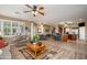 Bright, open living space with breakfast bar, ceiling fans, and tile flooring at 17637 N Goldwater Dr, Surprise, AZ 85374