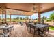Inviting covered patio with a ceiling fan, comfortable seating, and golf course view at 17637 N Goldwater Dr, Surprise, AZ 85374
