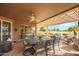 Inviting covered patio with golf course views, seating, and an outdoor dining area at 17637 N Goldwater Dr, Surprise, AZ 85374