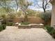 Spacious backyard with travertine pavers, outdoor kitchen, and ample greenery at 18515 N 94Th St, Scottsdale, AZ 85255