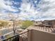 Balcony view showcasing neighborhood, mountain views, and blue skies with fluffy white clouds at 18515 N 94Th St, Scottsdale, AZ 85255
