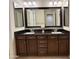 Stylish bathroom features a double vanity with dark wood cabinets and granite countertops at 18515 N 94Th St, Scottsdale, AZ 85255