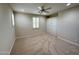 Carpeted bedroom with built-in wardrobe, ceiling fan and window with shutters at 18515 N 94Th St, Scottsdale, AZ 85255