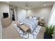 Staged bedroom shows neutral carpet, ceiling fan, bed with rug and furniture at 18515 N 94Th St, Scottsdale, AZ 85255