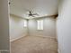 Empty bedroom shows tan carpet, ceiling fan and two windows with shutters at 18515 N 94Th St, Scottsdale, AZ 85255