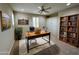 Bedroom staged as office with desk, bookcase, plantation shutters and ceiling fan at 18515 N 94Th St, Scottsdale, AZ 85255