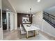 The formal dining area has a stylish light fixture, art display, and a modern dining table at 18515 N 94Th St, Scottsdale, AZ 85255