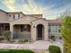 Inviting front entrance with arched doorway, quaint porch, and meticulously landscaped desert garden at 18515 N 94Th St, Scottsdale, AZ 85255