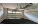 Spacious garage with a black tile floor and metal overhead storage racks at 18515 N 94Th St, Scottsdale, AZ 85255