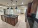 Open kitchen featuring a large island with modern appliances and plenty of countertop space, adjacent living room at 18515 N 94Th St, Scottsdale, AZ 85255