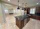 A spacious kitchen showcases dark wood cabinets, granite countertops, and a center island at 18515 N 94Th St, Scottsdale, AZ 85255