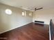 Hardwood flooring living area has dark ceiling fan, media center and circular window at 18515 N 94Th St, Scottsdale, AZ 85255