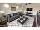 Staged living room with hardwood floors, dark ceiling fan, sofa and rug at 18515 N 94Th St, Scottsdale, AZ 85255