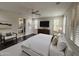 A furnished main bedroom features a large bed, ensuite bathroom, and plantation shutters at 18515 N 94Th St, Scottsdale, AZ 85255