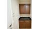 Mud room featuring dark cabinets, granite countertop, providing both functionality and style at 18515 N 94Th St, Scottsdale, AZ 85255