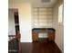 Office nook has hardwood floors, granite countertop, cabinets, shelving and shuttered window at 18515 N 94Th St, Scottsdale, AZ 85255
