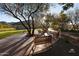 Picturesque outdoor seating area with mature trees and scenic golf course views at 18515 N 94Th St, Scottsdale, AZ 85255
