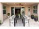 Covered patio featuring tile flooring and an outdoor dining set with seating for eight at 18515 N 94Th St, Scottsdale, AZ 85255