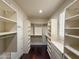 Walk-in closet offering ample storage with built-in shelving and hanging rods at 18515 N 94Th St, Scottsdale, AZ 85255