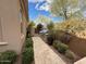 Inviting walkway leads to a built-in outdoor kitchen with lush landscaping at 18515 N 94Th St, Scottsdale, AZ 85255