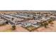 Aerial view showcasing a neighborhood with houses and a distant mountain range at 20358 N Valencia N Dr, Maricopa, AZ 85138